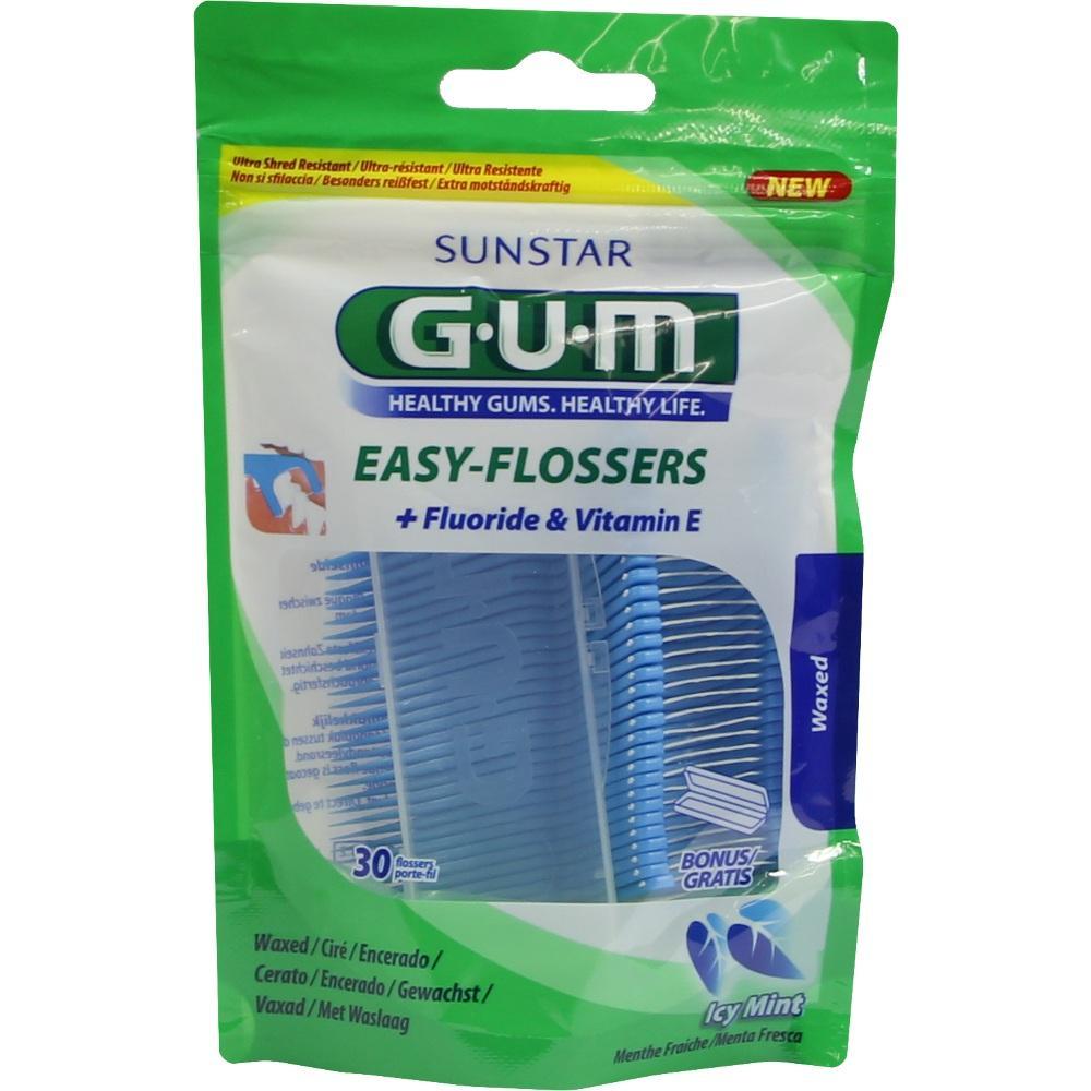 Eine Packung Zahnseide-Sticks mit Fluorid und Vitamin E in gr&uuml;nem Beutel.